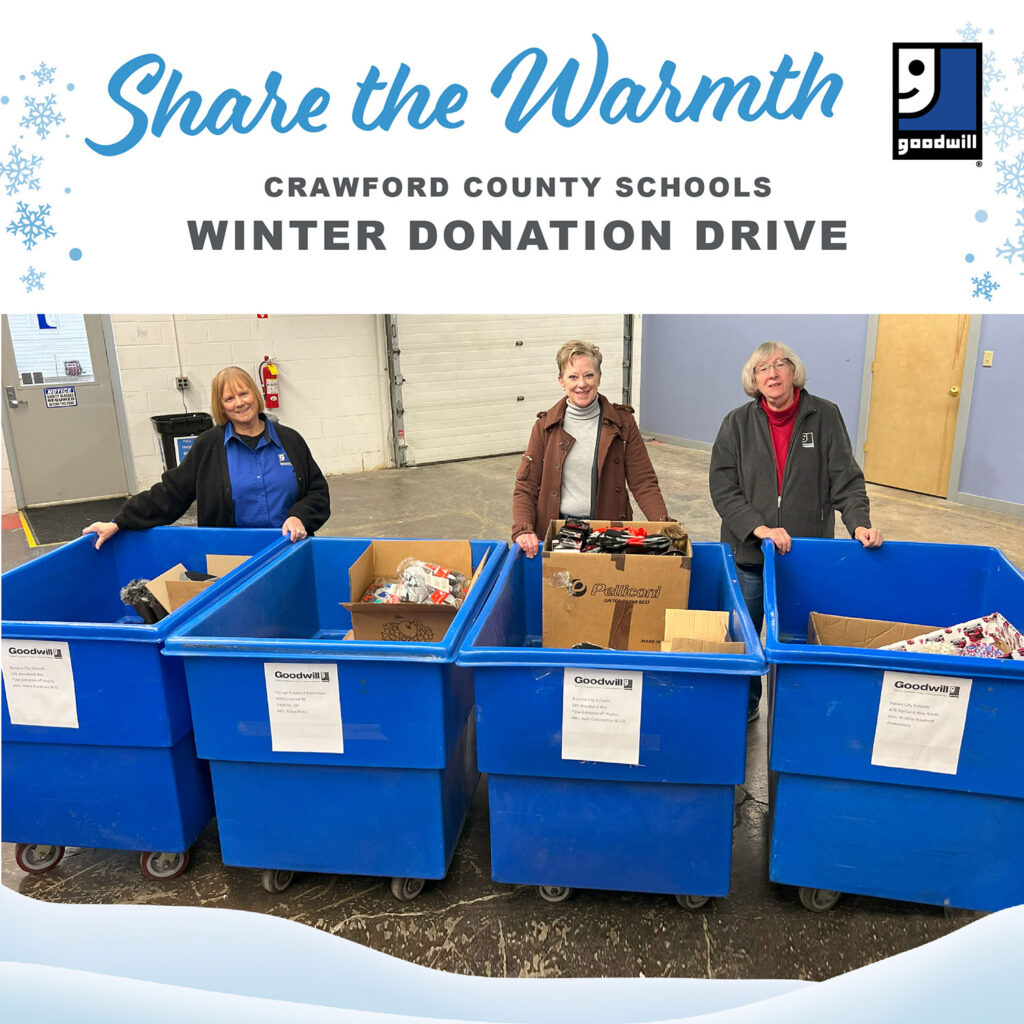 Goodwill employees standing with donation bins at the Crawford Co Schools Winter Donation Drive event.